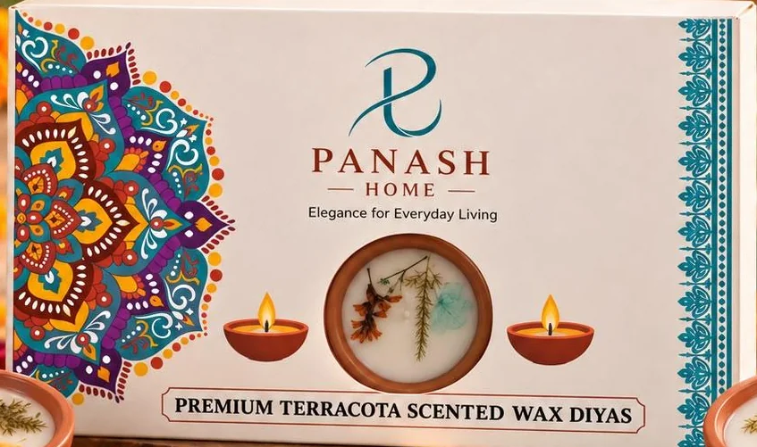 The PANASH HOME gift box: a white sleeve with a vivid teal, purple and saffron mandala on one side, a teal border on the other, the PANASH HOME logo and a window showing one diya.